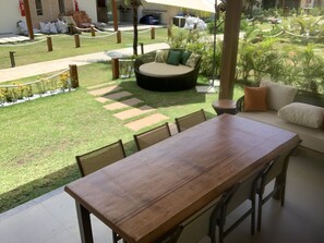 Varanda with a large dining area, 3-seats sofa, double lounge view to the ocean.