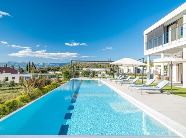 Spacious gated pool surrounded by sun loungers on the patio of the luxury villa with elevator Bracchia 2 Magic Retreat on the island of Brac
