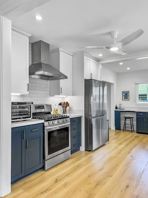 Our gourmet kitchen is equipped with premium appliances and ample counter space for creating fresh island meals with ease.