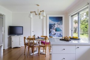 A bonus TV in the dining area means the cook can watch their favourite shows while whipping up dinner for the group.