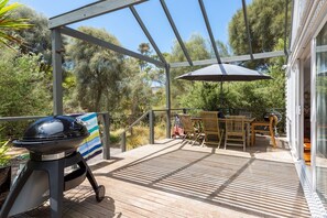 The back deck offers alfresco dining under the shade of an umbrella. Fire up the BBQ to enjoy a true Aussie feast.