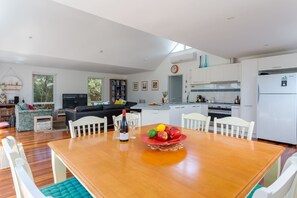 An oversized dining table allows for family meals or game nights at home.