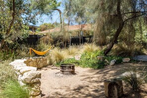 The backyard is a lush retreat, with a hammock for lazy afternoons flipping the pages of your favourite book and fire pit for cosy nights under the stars.
