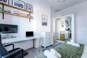 Bedroom 2 benefits from a comfortable king bed, a desk with monitor and plenty of storage.