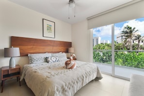 Unwind in a king bed with soft pillows as ocean breezes create a dreamy escape.