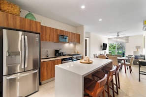 Enjoy our kitchen: stylish island, three stools—where cooking meets comfort, every meal savored.