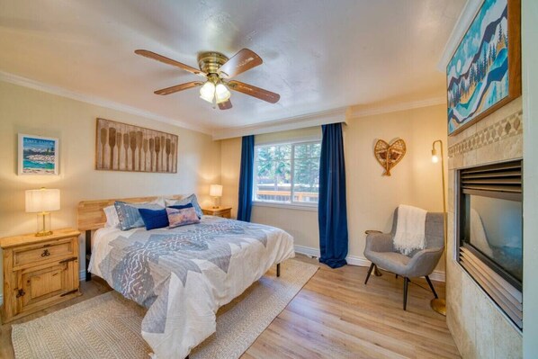 Master bedroom equipped with queen size bed and gas fire place, along with the attached master bathroom.