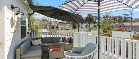 Patio with comfortable seating andd umbrellas