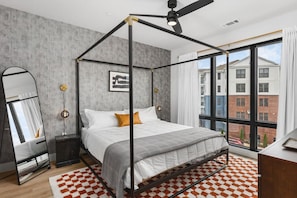 Primary bedroom with a king bed, Smart TV, ensuite bath, and room darkening shades. Tastefully decorated with high-end modern furnishings and thoughtful touches to make your stay as comfortable as possible.