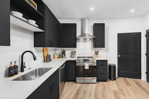 Fully stocked kitchen with stainless steel appliances and all the dishware / utensils you might need.