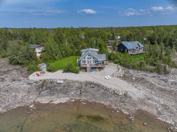 Welcome to Elysium Cottage, where you can immediately feel the stress leave your body. Enjoy the beautiful, private lot with stunning views of Lake Huron.