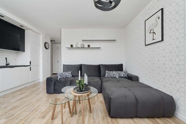 Relax in the stylish living room with a comfortable sofa and modern decor.