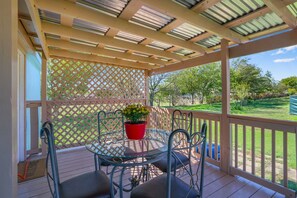 Covered outdoor dining up the stairs on the front porch