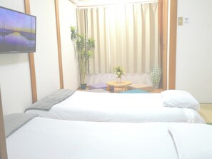 This is a Japanese-style bedroom on the second floor. It has two thick mattresses and futons. There is also a smart TV. You can watch Netflix and YouTube.