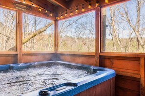 Relax in the steamy hot tub while taking in the waterfront view