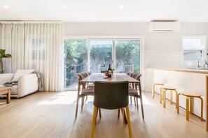 A timber table seats all six guests for meals at home.