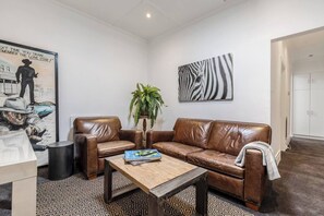 A separate TV room is complete with a comfy sofa and armchair to enjoy relaxed movie nights.
