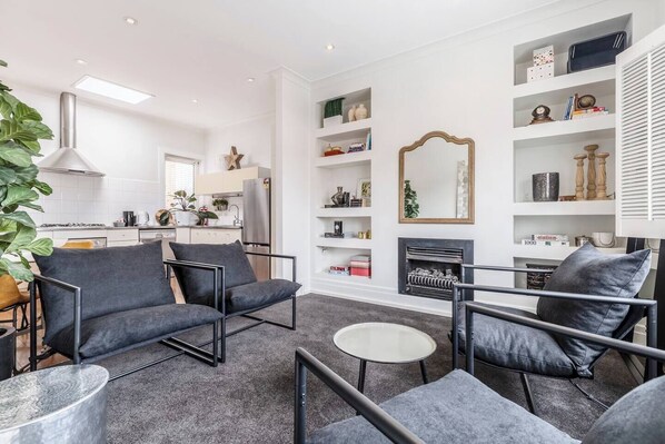 The light-filled living area includes four cosy armchairs, with split system air-conditioning and radiator wall heating ensuring year-round comfort.
