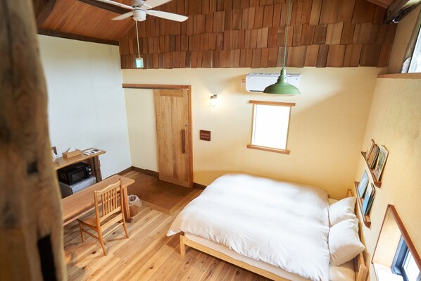 Main queen size bed. Wide ceiling gives an open feeling