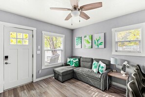 Bright and spacious living area with a fully equipped kitchen at Cozy Great Falls Retreat by Wrecked & Refined – ideal for gatherings.