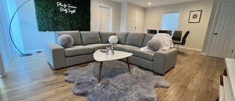 Beautiful modern living room with a large L-shaped sectional sofa, coffee table