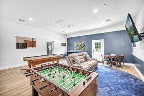 Gameroom with a MEGA-size TV, foosball, poker table, bar & pool table!