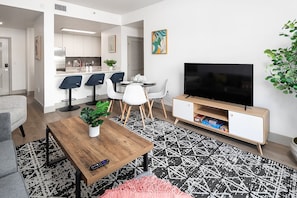 Unwind in the spacious living area complete with a comfy couch, 50-inch TV, and dining area!