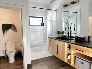Main house: Bathroom #3 downstairs with access to laundry off of kitchen area