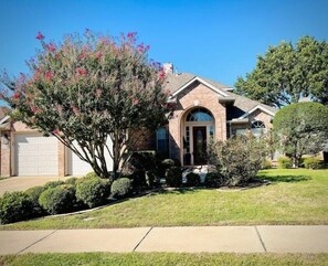 Home street view with lots of parking in driveway & street, directly in front.