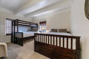 A main-level bedroom makes efficient use of its space with two twin-over-queen bunk beds.
