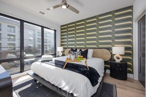 Primary bedroom with King bed, smart TV, large walk-in closet, and ensuite bathroom with walk-in shower.