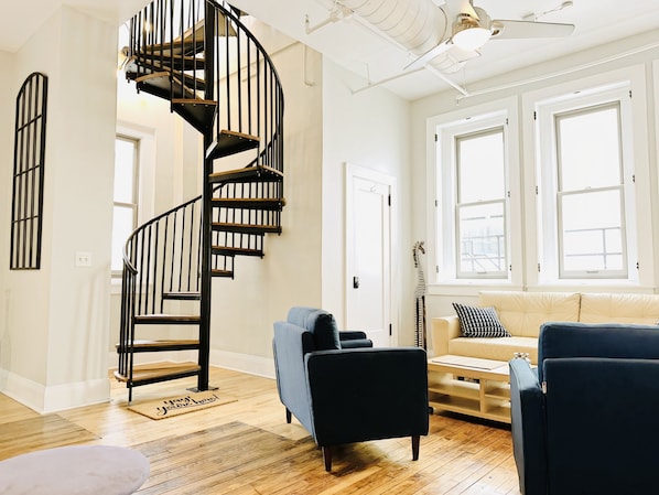 Stylish loft with spiral stairs to a rooftop view. #Airbnb #CityViews