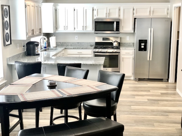 Beautiful kitchen with granite countertop, stainless steel appliances and pantry