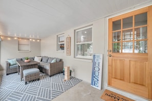 Screened in porch overlooking the fenced in backyard