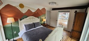 Bedroom 1, with a queen bed (courtyard view shown)