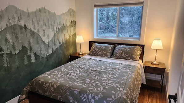 Bedroom 2, with double bed and backyard view.