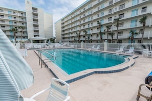 Lounge by the large heated pool surrounded by plenty of seating for sunny days and peaceful evenings