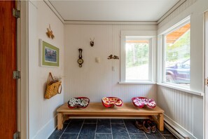 Porch entry, lots of space to hang jackets, leave boots and shoes. 
