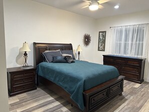 Queen bedroom with ceiling light/fan. Bathroom is next to the queen bedroom.