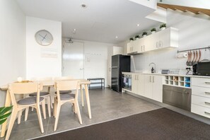 Enjoy meals with ease at this open-plan dining area, featuring a stylish 4-seater table perfect for gatherings.