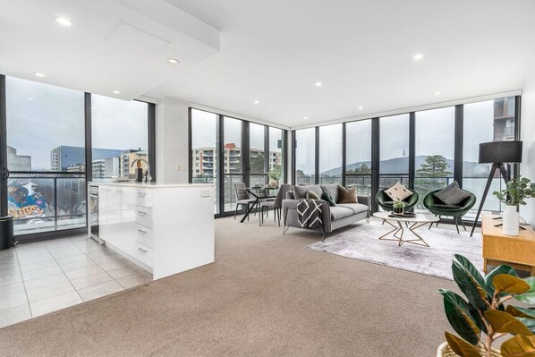 Enjoy seamless functionality in this modern open-plan dining and kitchen area, where style meets convenience.