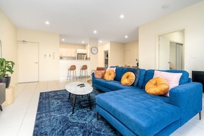 A cosy living room perfect for entertaining friends and family. Feel at ease with our clean looking comfy sofa and soft throws.