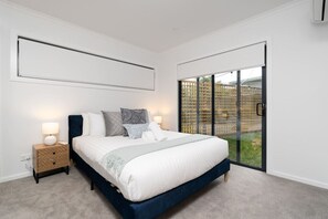 Relax in a spacious bedroom featuring professionally laundered linens, ensuring a cosy and clean experience.