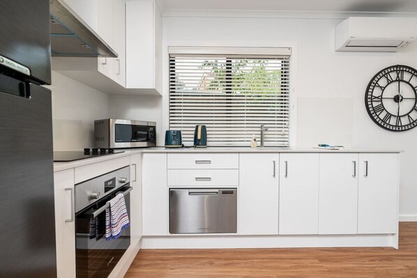 Contemporary kitchen featuring modern fixtures and finishes, offering a stylish and functional space for all your culinary needs.