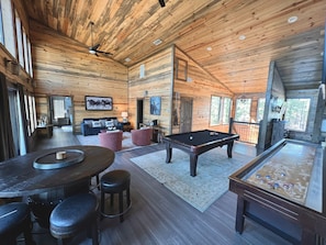Large game room on upper level with a variety of games and 75" TV!