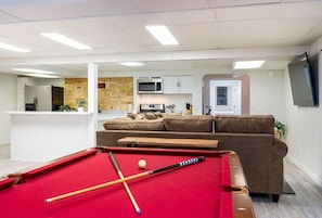 Welcome to our lively rec room, furnished with a standard pool table, offering endless entertainment for you and your guests.