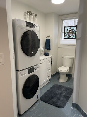 Full bathroom with washer and dryer.