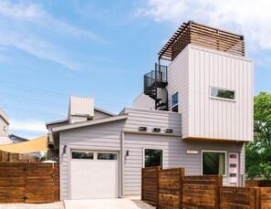 The house has 2 parking spots in front, private fenced in backyard, and two rooftop decks.