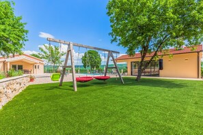 Outdoor playground area with swings