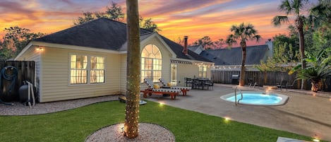 Private backyard with a cozy fire pit, grill, lounge chairs, and plunge pool.